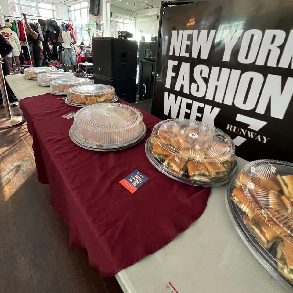 The Sandwich Shop's catering platters of sandwiches on a table at a New York Fashion Week event.